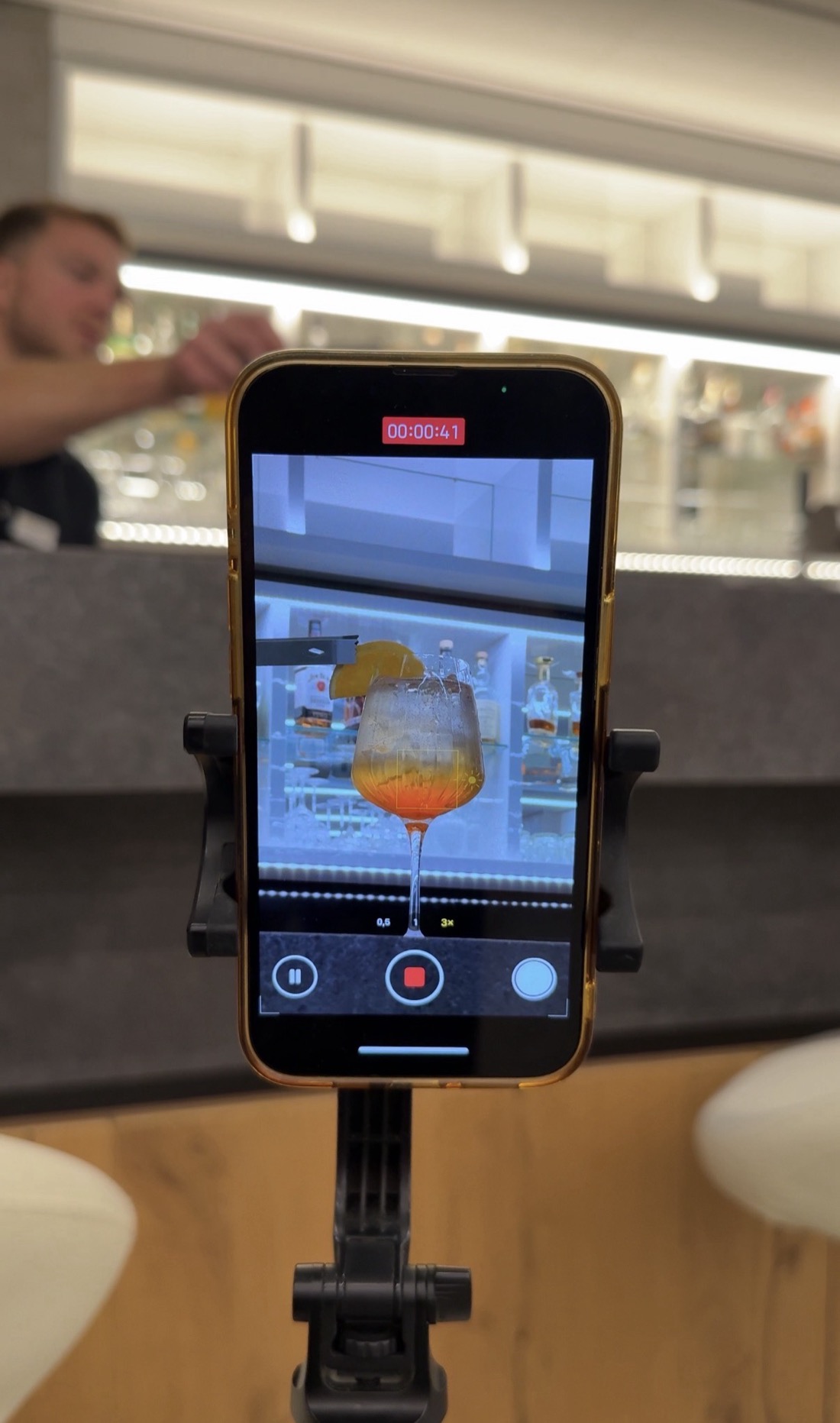 PRES. filming cocktail content on-site at a resort bar.